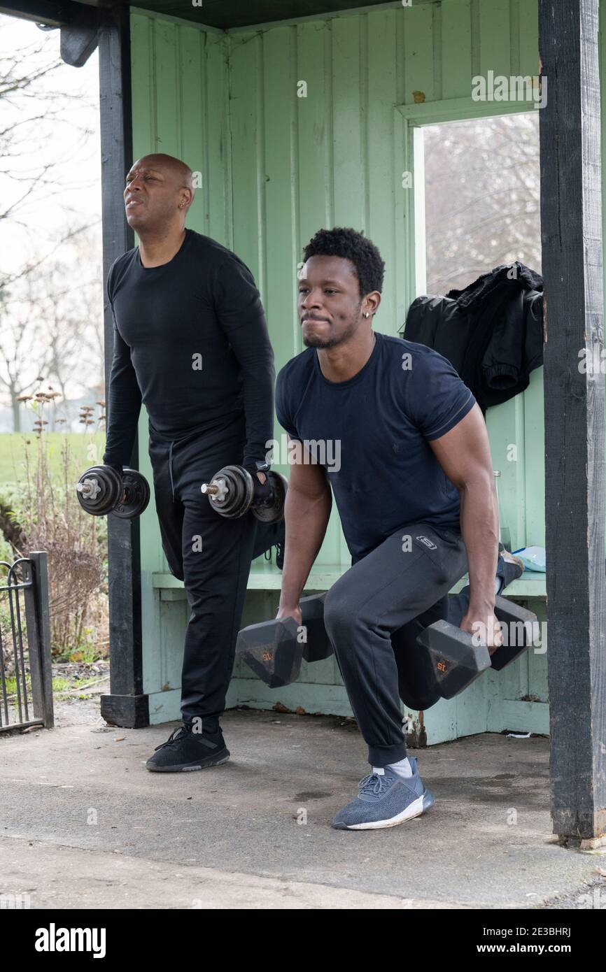 Men lifting weights during a fitness training session in Brockwell Park on the 15th January 2021 in South London, England. Photo by Sam Mellish Stock Photo