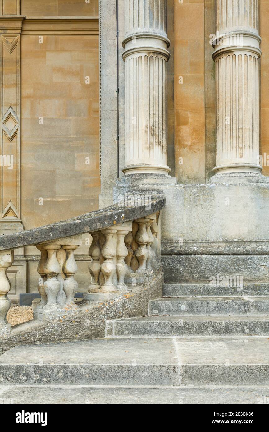 Ancient manor house exterior with stone steps, balustrade and columns, UK Stock Photo