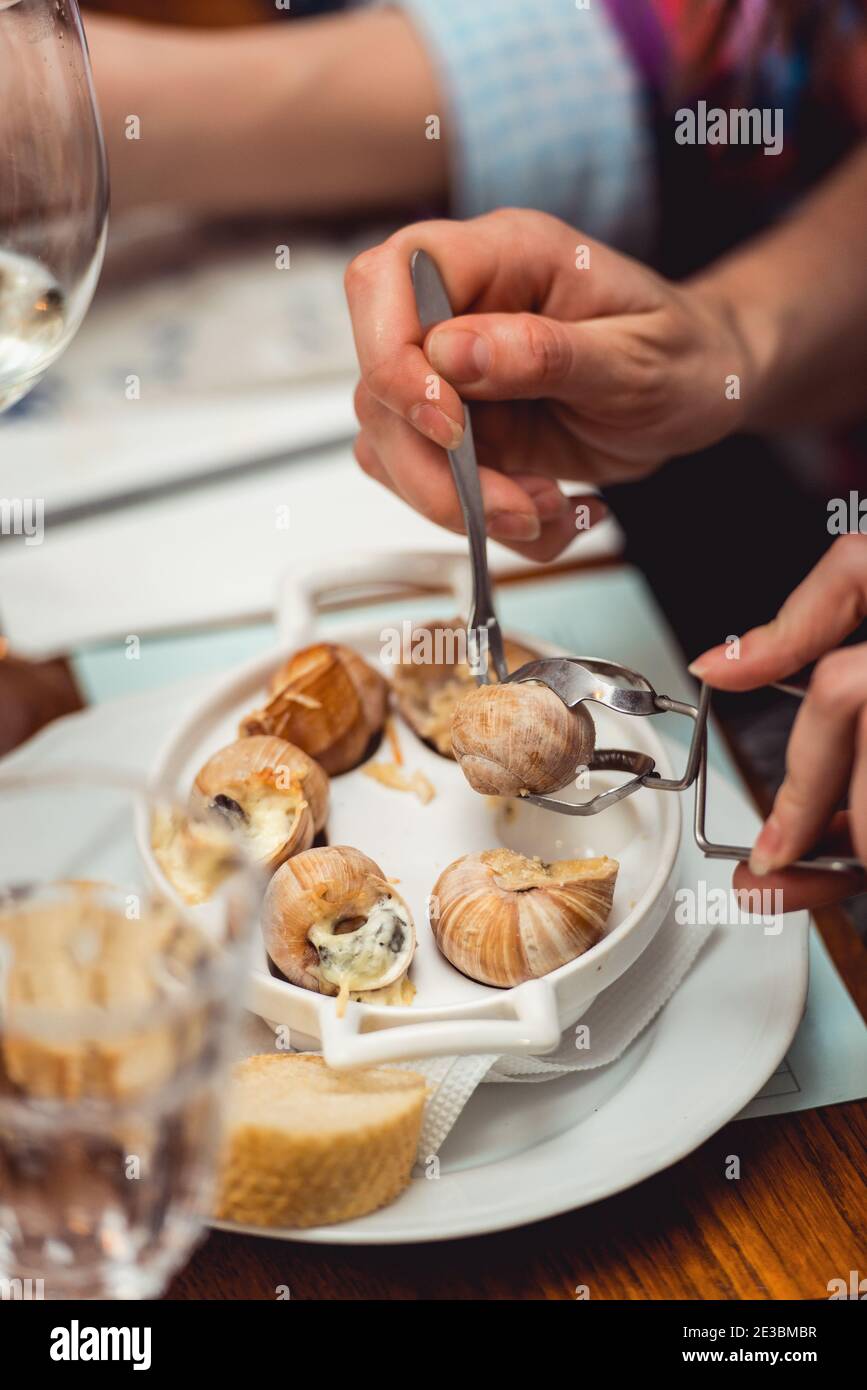 Snails with herbs butter, in traditional ceramic pan bread and s Stock