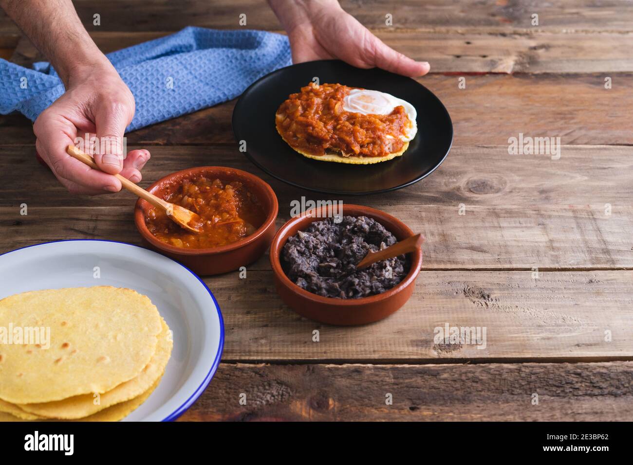 Process of elaboration of huevos rancheros. Mexican cuisine. Copy space. Stock Photo