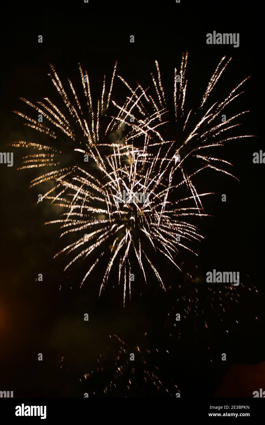 Colorful fireworks set on the dark black nite sky background Stock Photo