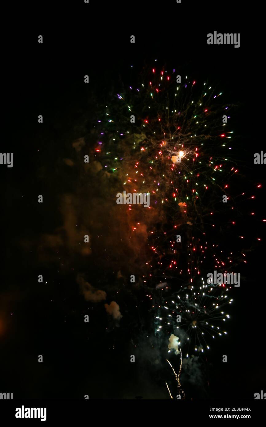 Colorful fireworks set on the dark black nite sky background Stock Photo