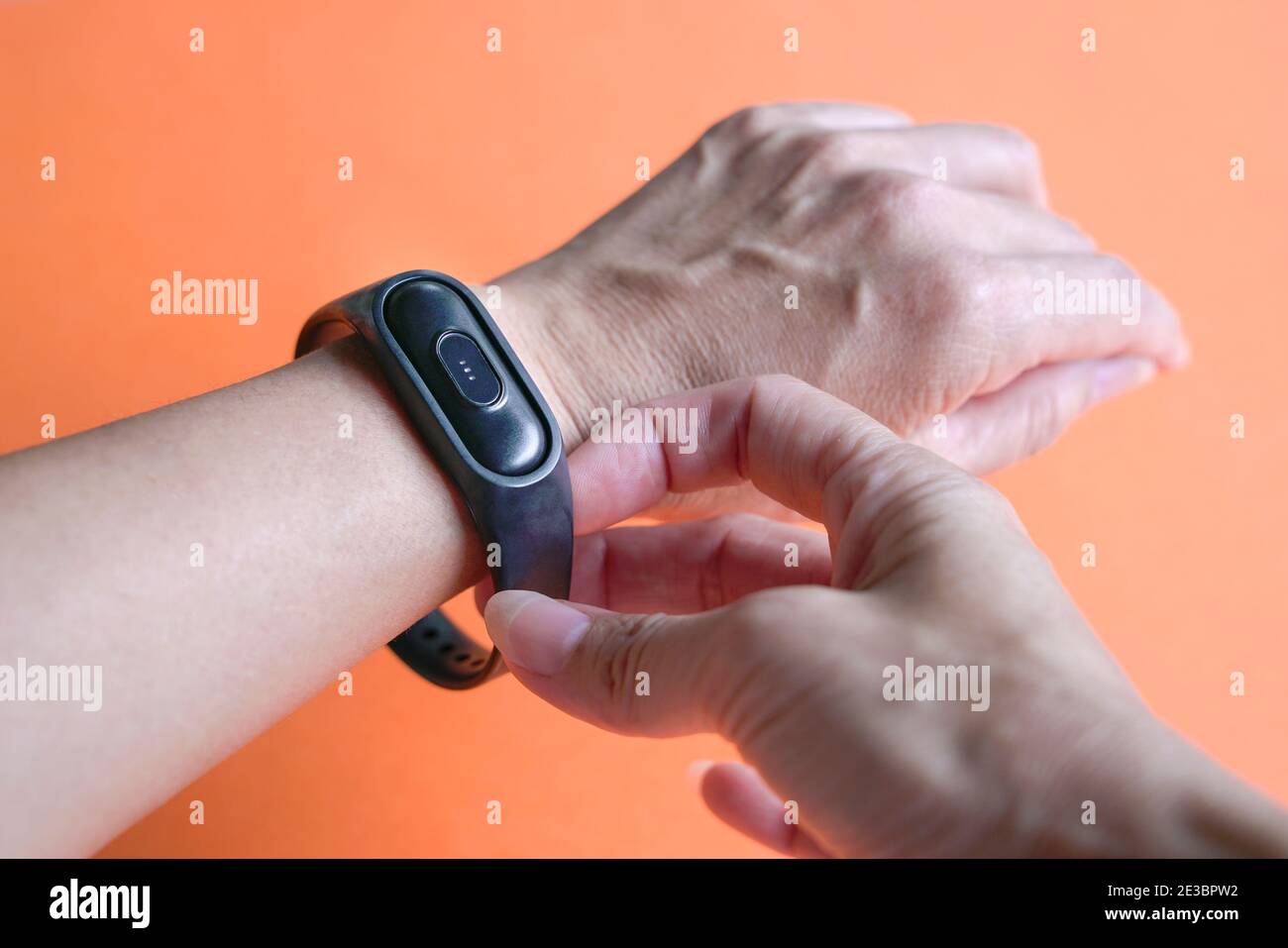 Woman wearing intelligent health watch on her wrist. Close up view. Stock Photo
