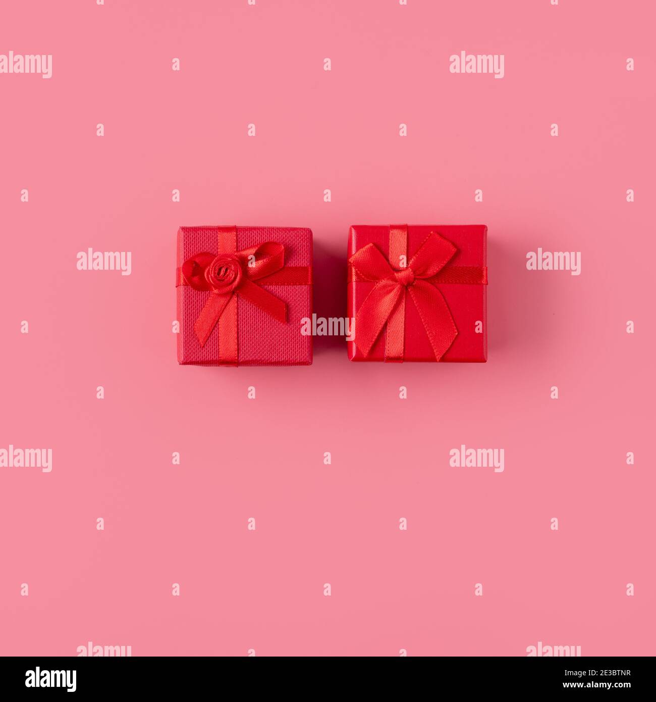 Beautiful gift box wrapped with ribbon bow on pastel pink background ...