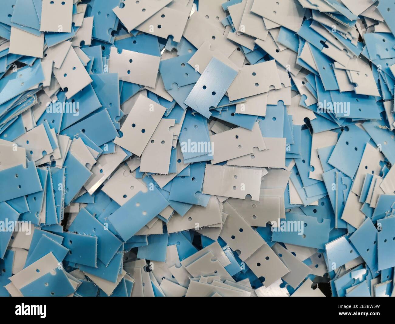 Bunch of white and blue plastic manufactured bits Stock Photo