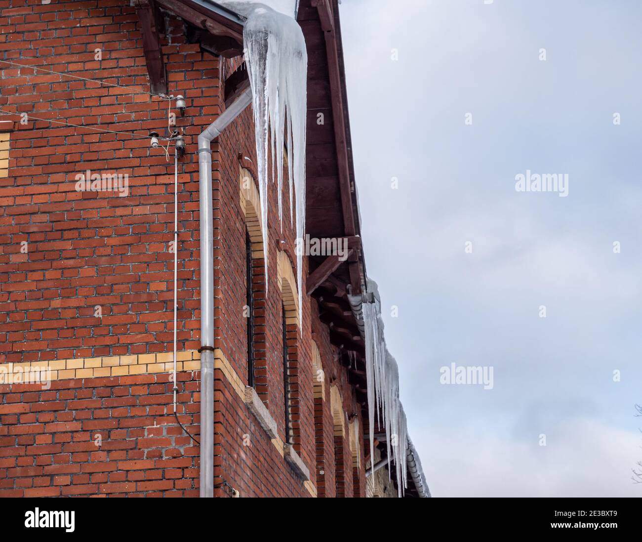 Icicles hang on the roof - mortal danger Stock Photo