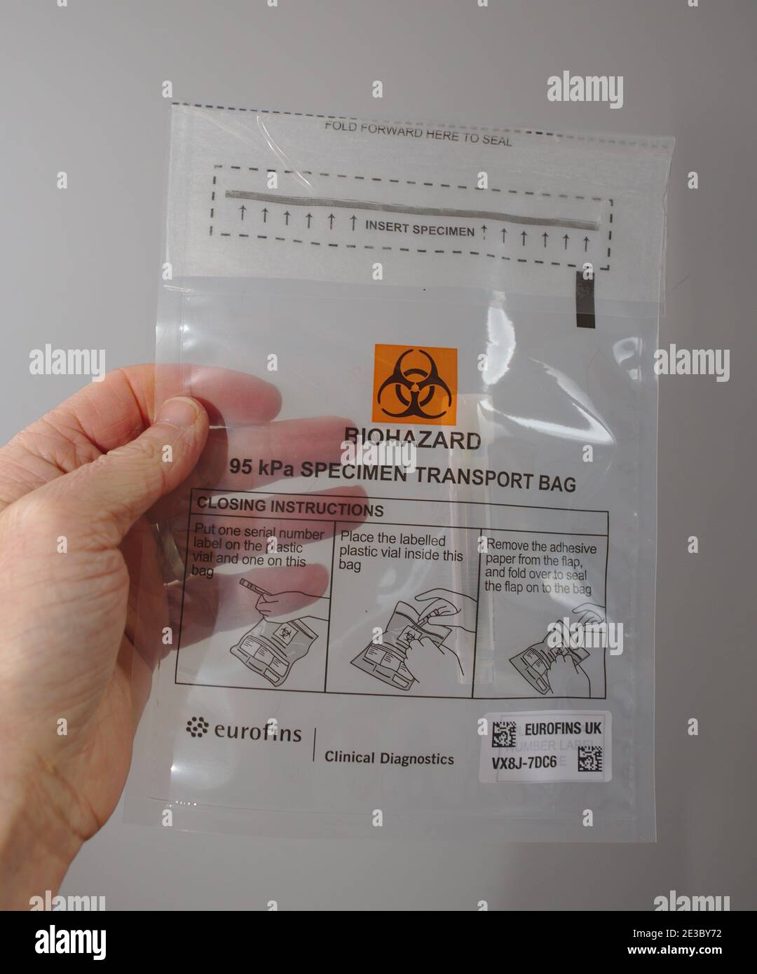 Coronavirus covid 19 home test kit sample in biohazard transport bag ready to be boxed and returned for testing. Stock Photo