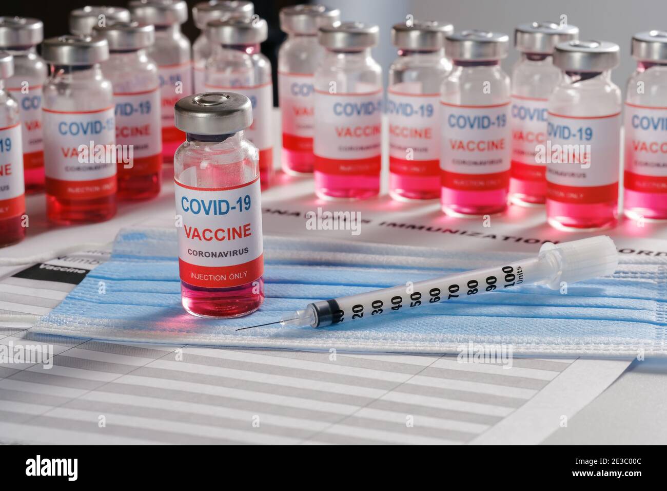 Vaccine vial, syringe and many glass bottles on background for vaccination  Stock Photo