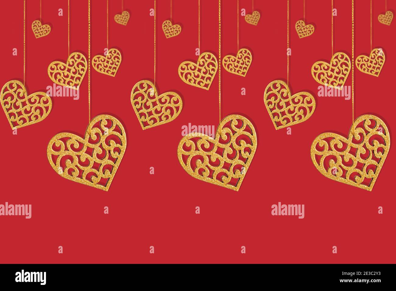 Seamless pattern with isolated yellow hearts with openwork cutout on a red background. Valentine's day or wedding concept. Stock Photo