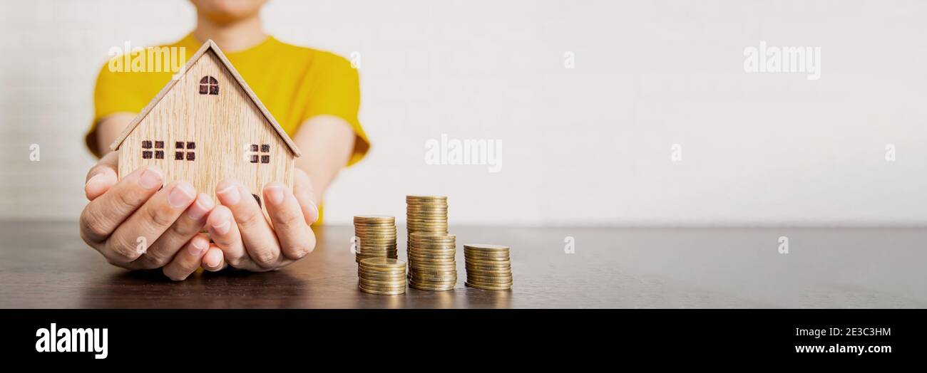 real estate, woman holding house and money on table, bet offer and low interest concept Stock Photo