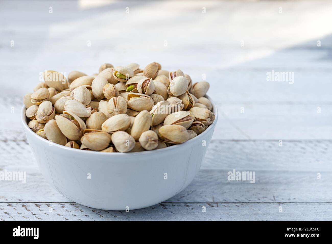 toasted pistachios in a bowl. Nuts vegan protein Stock Photo