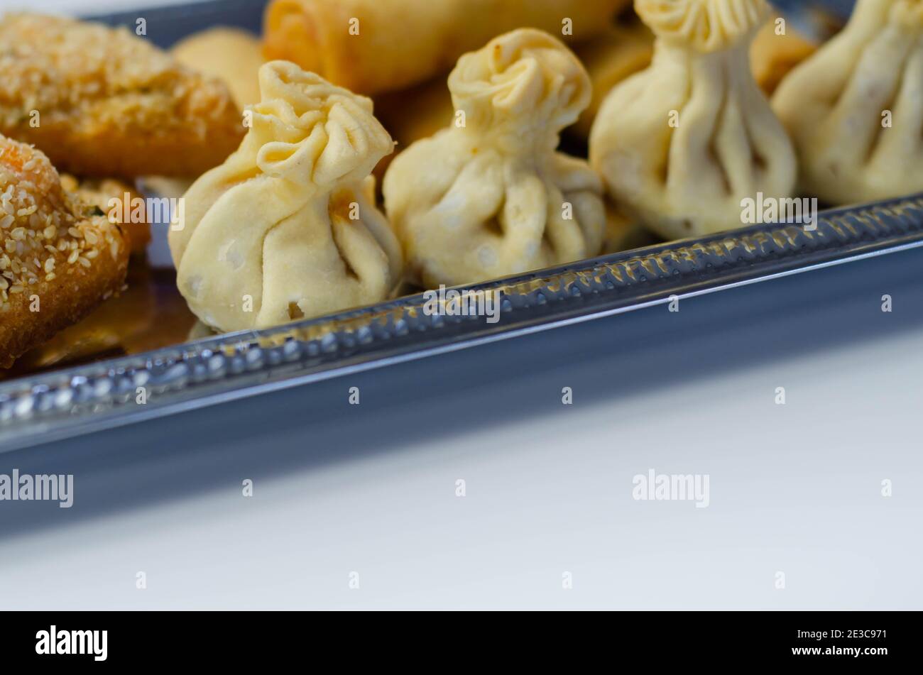 Sweet and sour vegetable wontons, Traditional chinese dumplings filled with bean sprouts, red