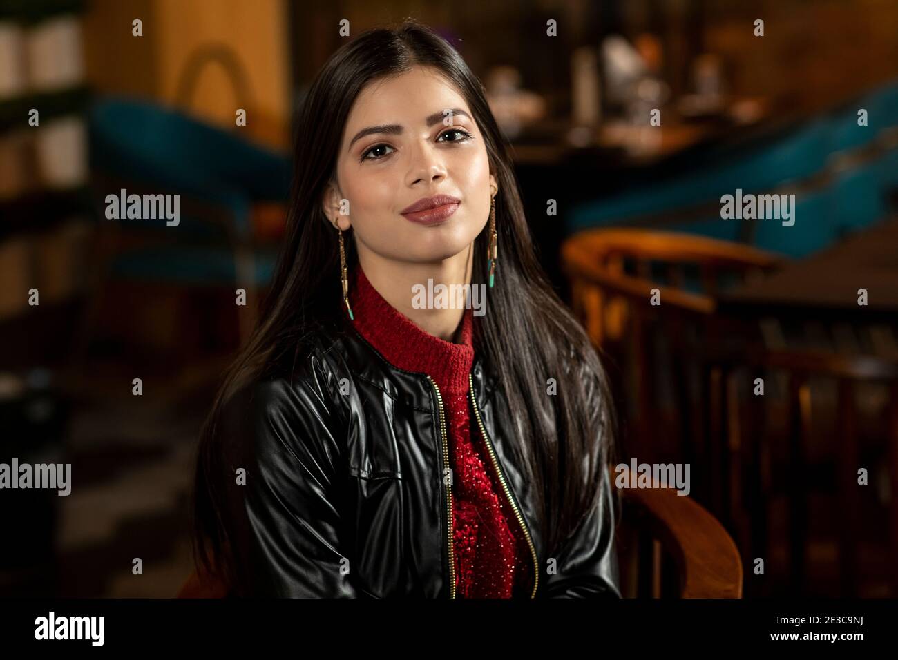 Portrait of a pretty young woman sitting in a restaurant Stock Photo ...