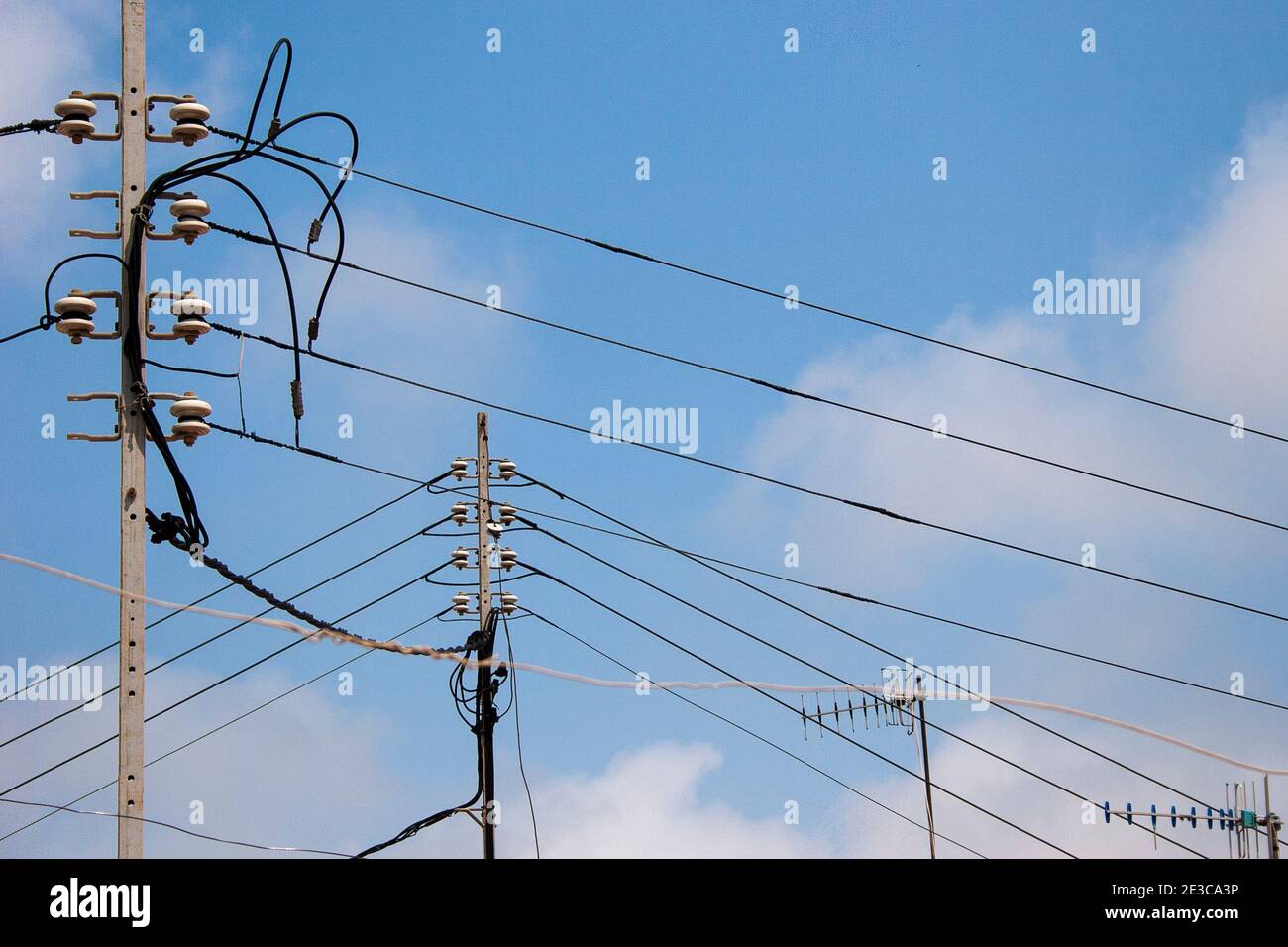 Overhead power cables and tv aerials above buildings in a traditional