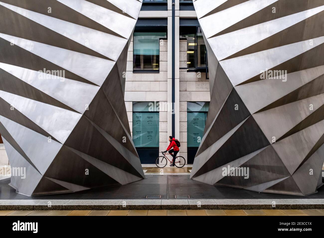A Young Man Cycles Past The Paternoster Vents, London, UK. Stock Photo