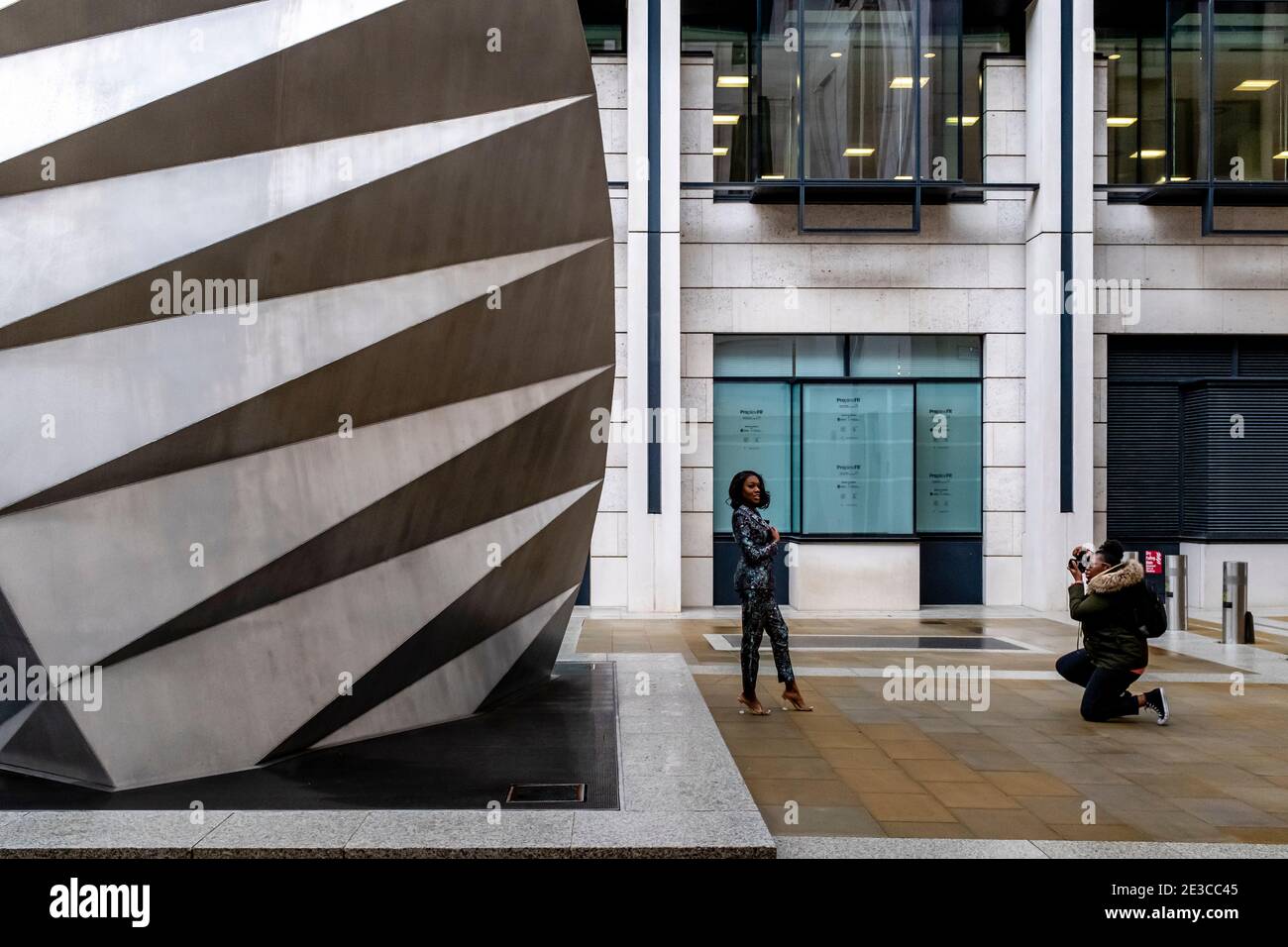A Young Woman Taking Photographs At The Paternoster Vents, London, UK. Stock Photo