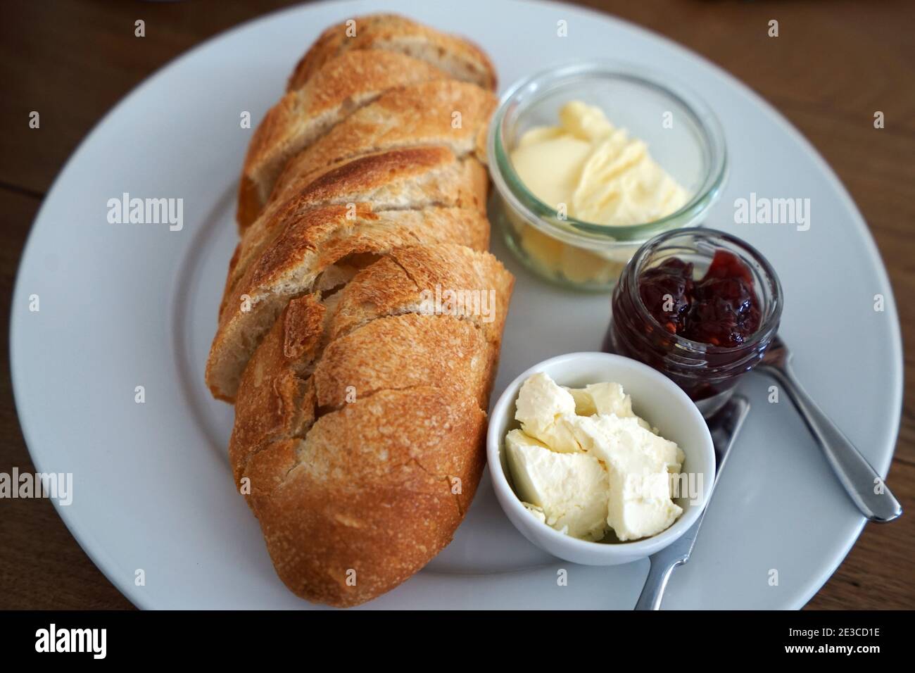 Close up plain Baguette served with butter clotted cream cheese and