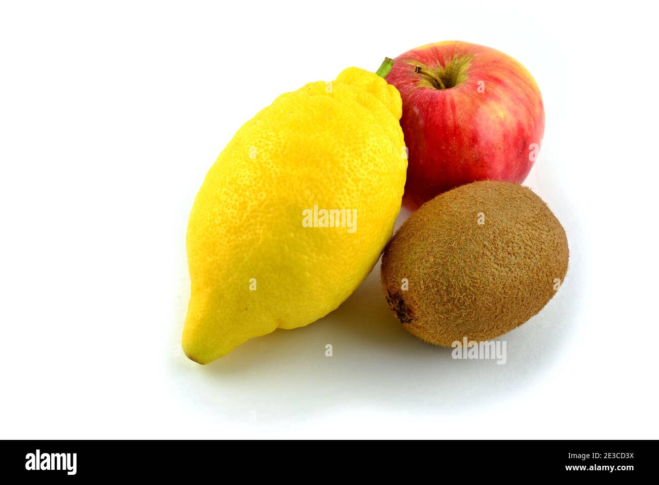 Mixture of fruits, one yellow lemon, one red apple, one brown kiwi. Stock Photo