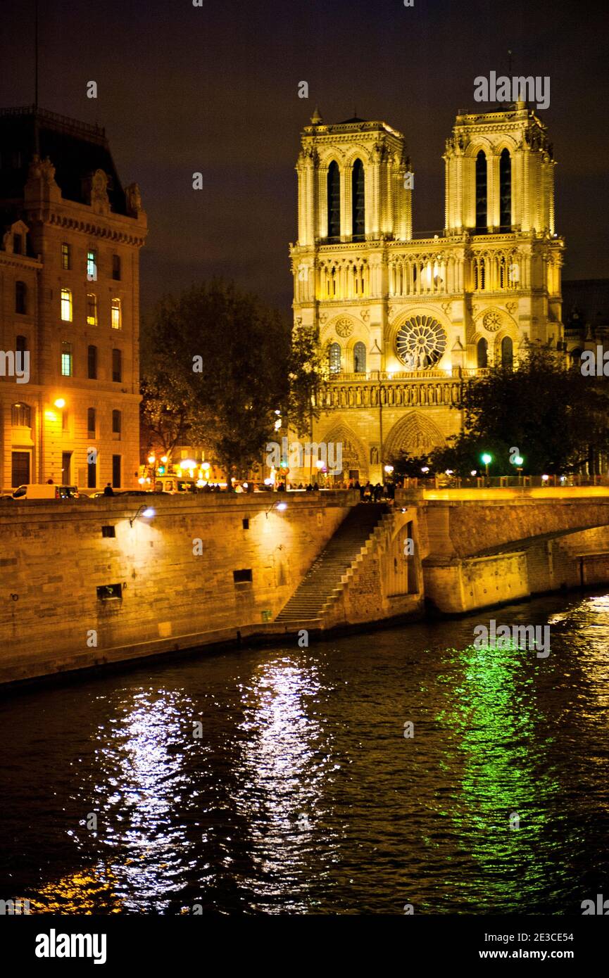 Notre Dame cathedral by night, seen from the Seine quays, Paris, France Stock Photo