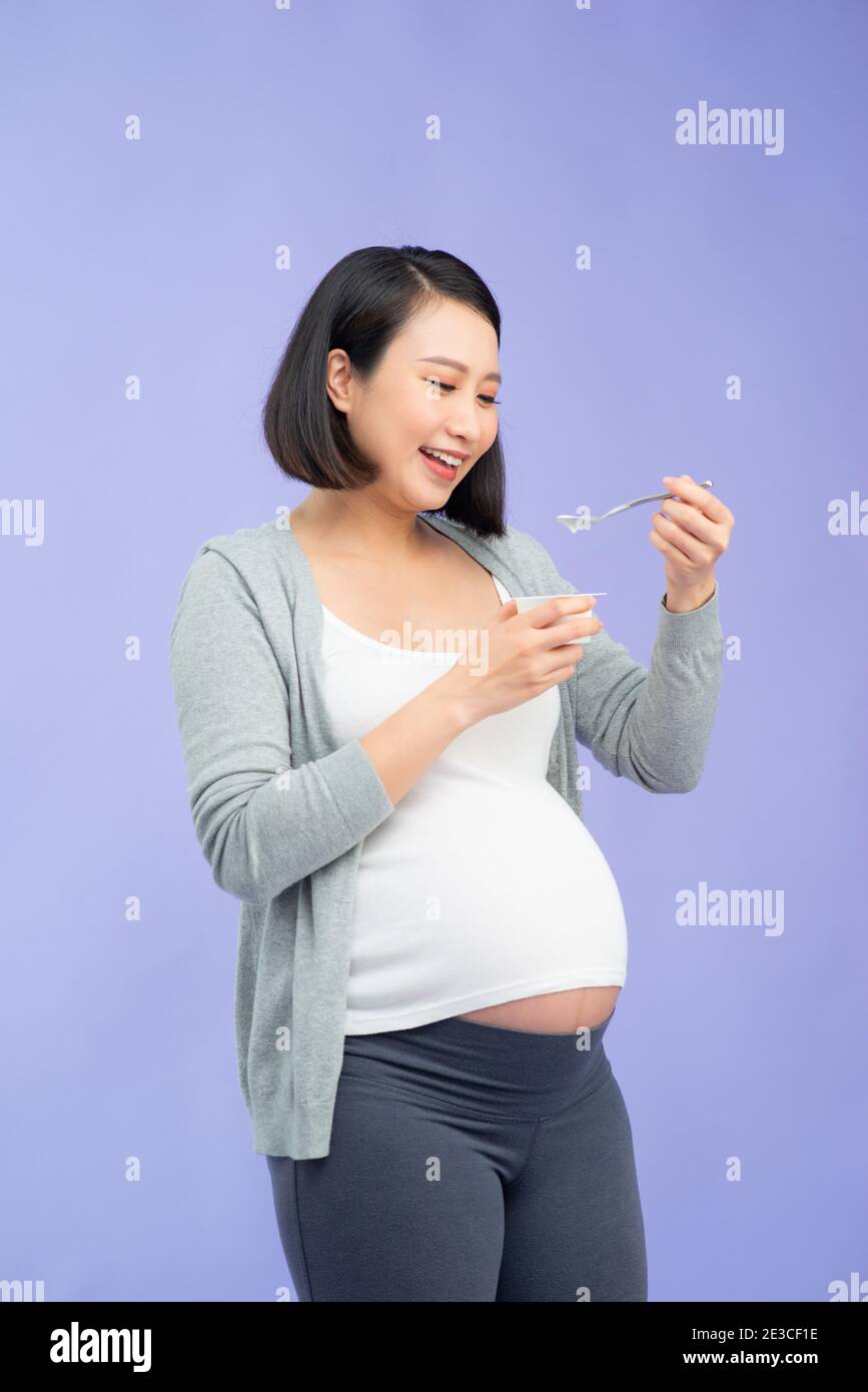 Portrait of pregnant woman eating yoghurt Stock Photo Alamy