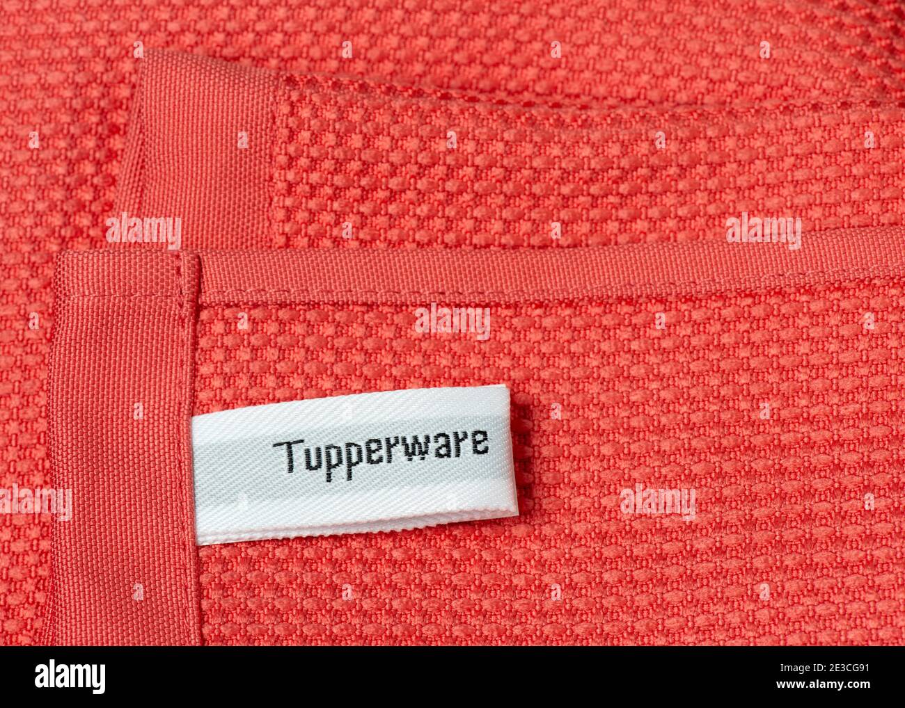 Tupperware writing logo sign label on pink microfiber cleaning cloth. Tupperware Brands home products. Stock Photo