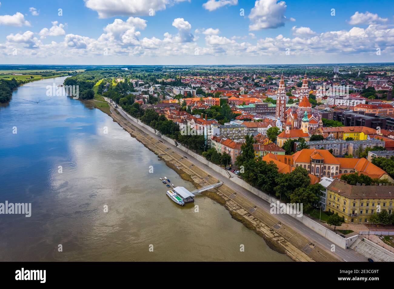 Szeged, Hungary - Aerial view of the Votive Church and Cathedral of Our Lady of Hungary (Szeged Dom) and River Tisza on a sunny summer day with blue s Stock Photo