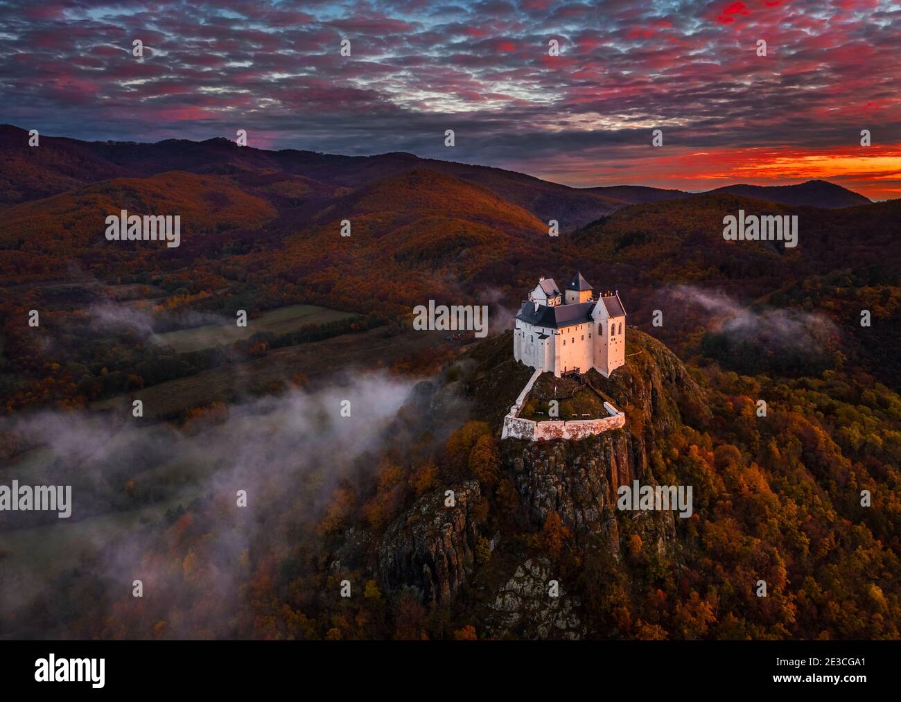 Fuzer, Hungary - Aerial view of the beautiful Castle of Fuzer with amazing colorful sunrise sky and clouds on an autumn morning. The castle has been l Stock Photo