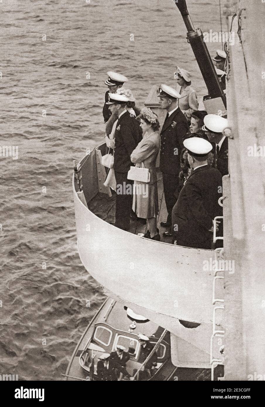 EDITORIAL ONLY Princess Elizabeth of York and Prince Philip, seen here when he was Lieutenant Philip Mountbatten, accompanying her father King George VI on board the H.M.S. Maidstone during an inspection of the Home Fleet in the Clyde. George VI (Albert Frederick Arthur George),1895 –1952. King of the United Kingdom and the Dominions of the British Commonwealth. Princess Elizabeth of York, future Elizabeth II, born 1926. Queen of the United Kingdom. Prince Philip, born Prince Philip of Greece and Denmark, 1921. Husband of Queen Elizabeth II of the United Kingdom. From The Queen Elizabeth Stock Photo