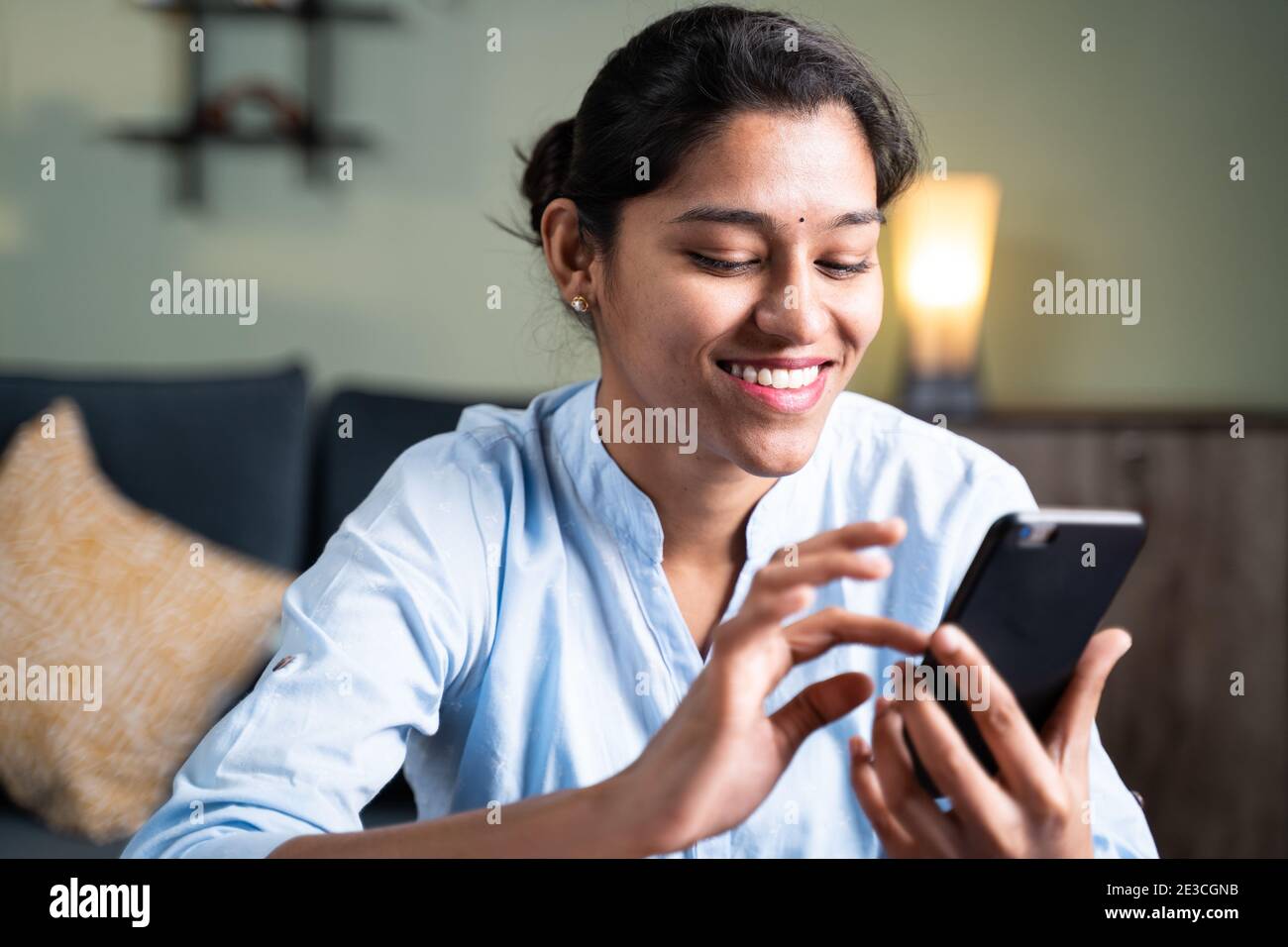 young man smiling by reading funny message or sms on mobile phone - Concept  of using social media, online messaging app, Internet and entertainment li  Stock Photo - Alamy