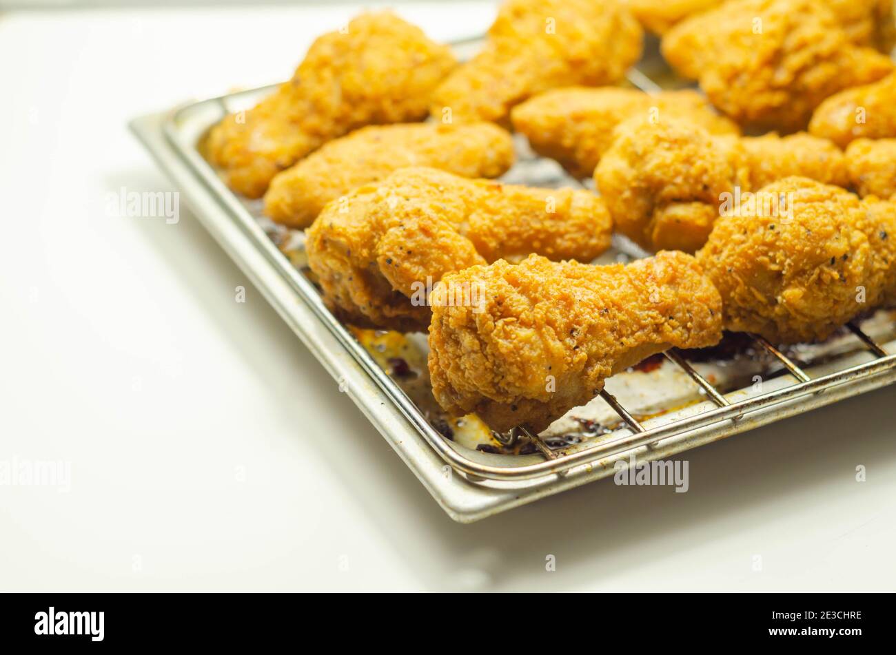 Southern crispy battered fried chicken wings, deepfried chicken wings on the metal tray, fast