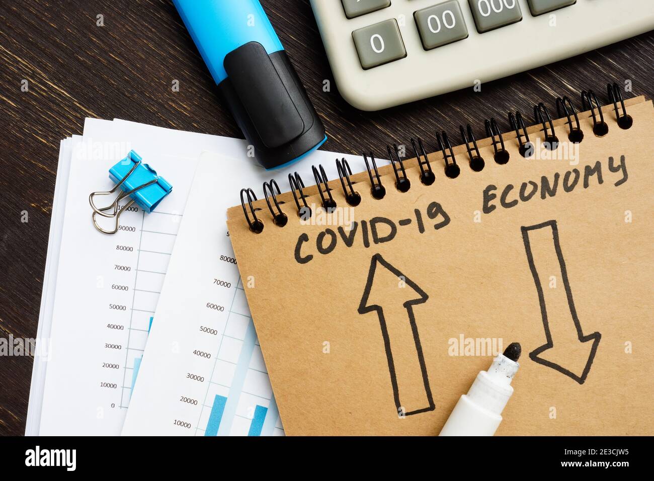 Covid-19 and economy crisis concept. Arrows on the page. Stock Photo