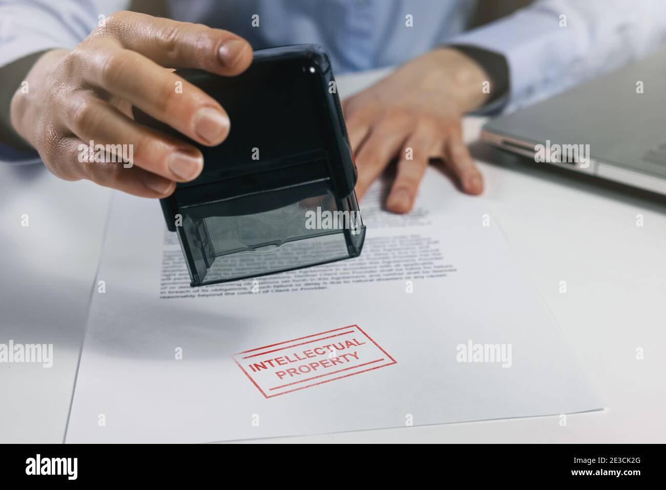 woman put a intellectual property stamp on document. copyright concept Stock Photo