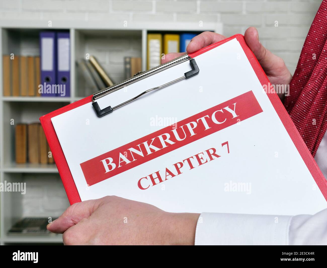 Clerk holds bankruptcy chapter 7 documents about insolvency. Stock Photo