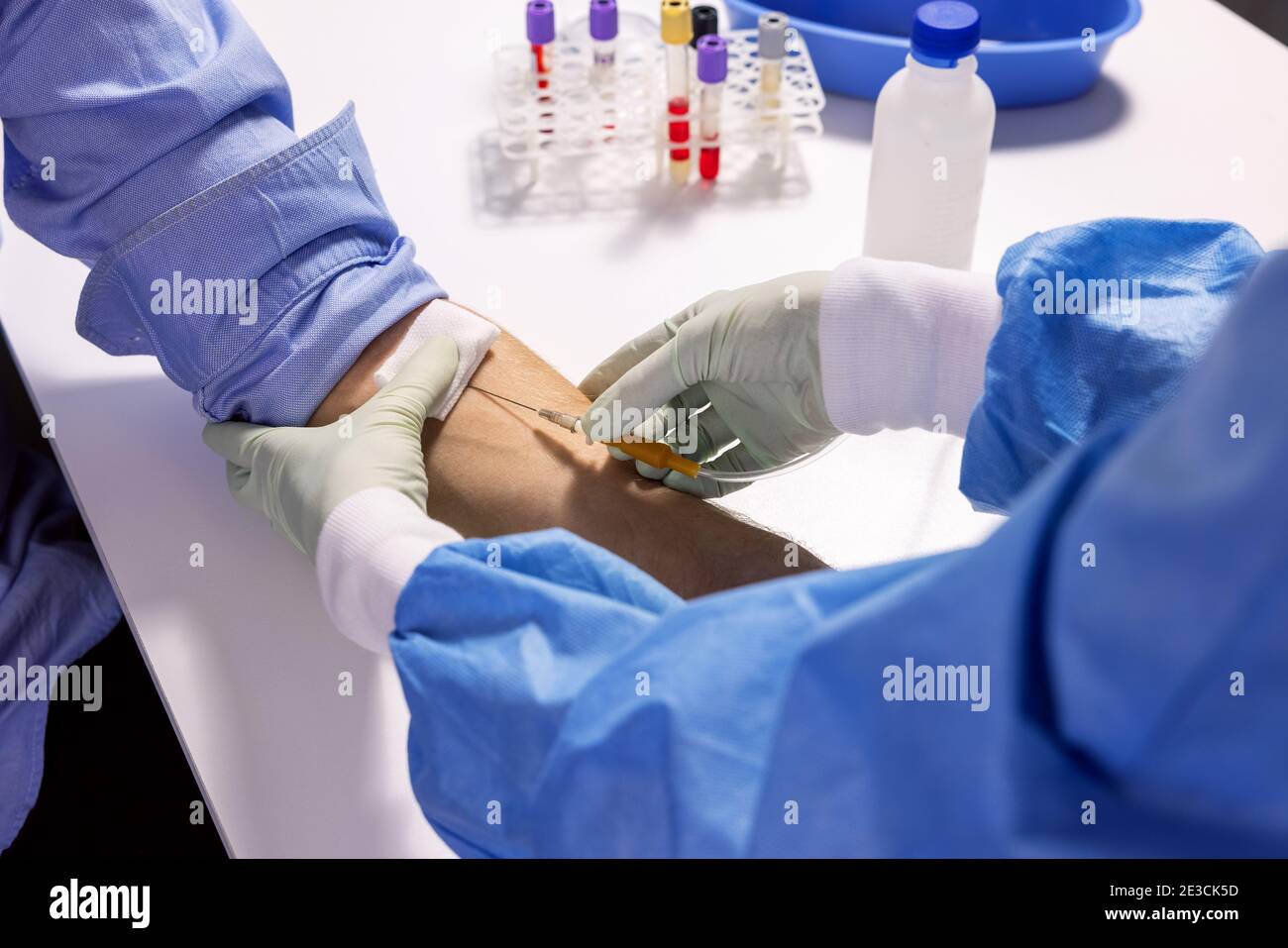 nurse injecting syringe in patient arm for blood donation or transfusion Stock Photo