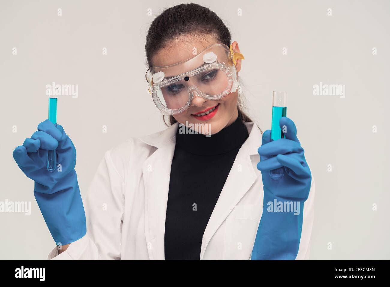 Young woman scientist working in chemical laboratory and examining biochemistry lab sample. Science technology medicine research and development study Stock Photo