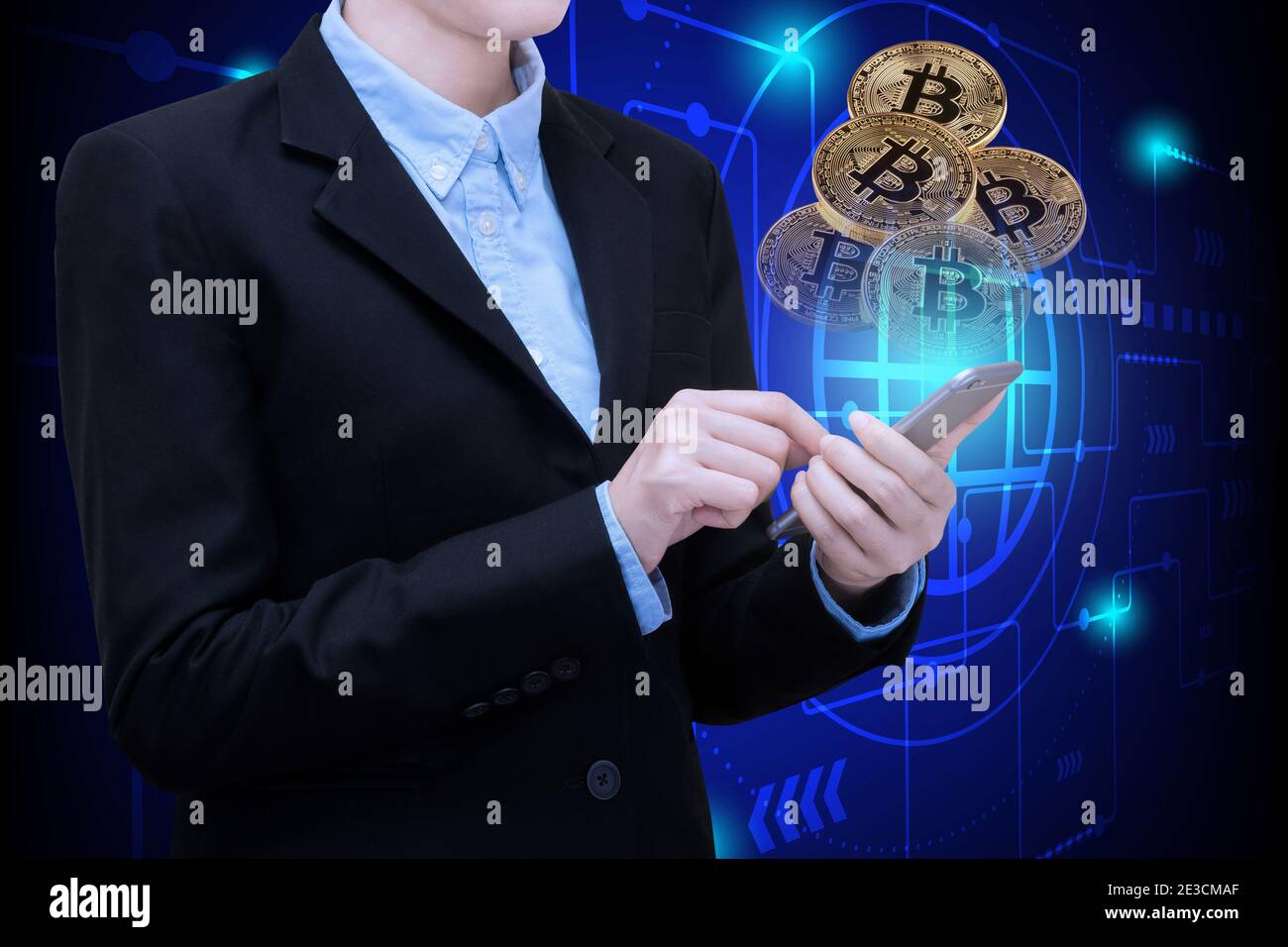 Business woman use smartphone technology invest in Bitcoin.Conceptual design for technology of Cryptocurrency and money investing. Stock Photo