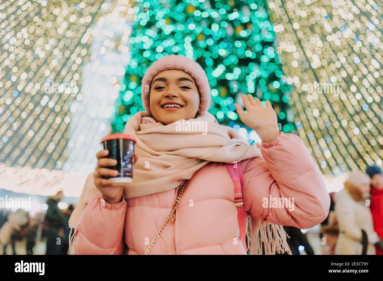 Young attractive african-american woman walking on the street during winter holidays. Merry Christmas and happy New Year! Happy smiling girl enjoying Stock Photo