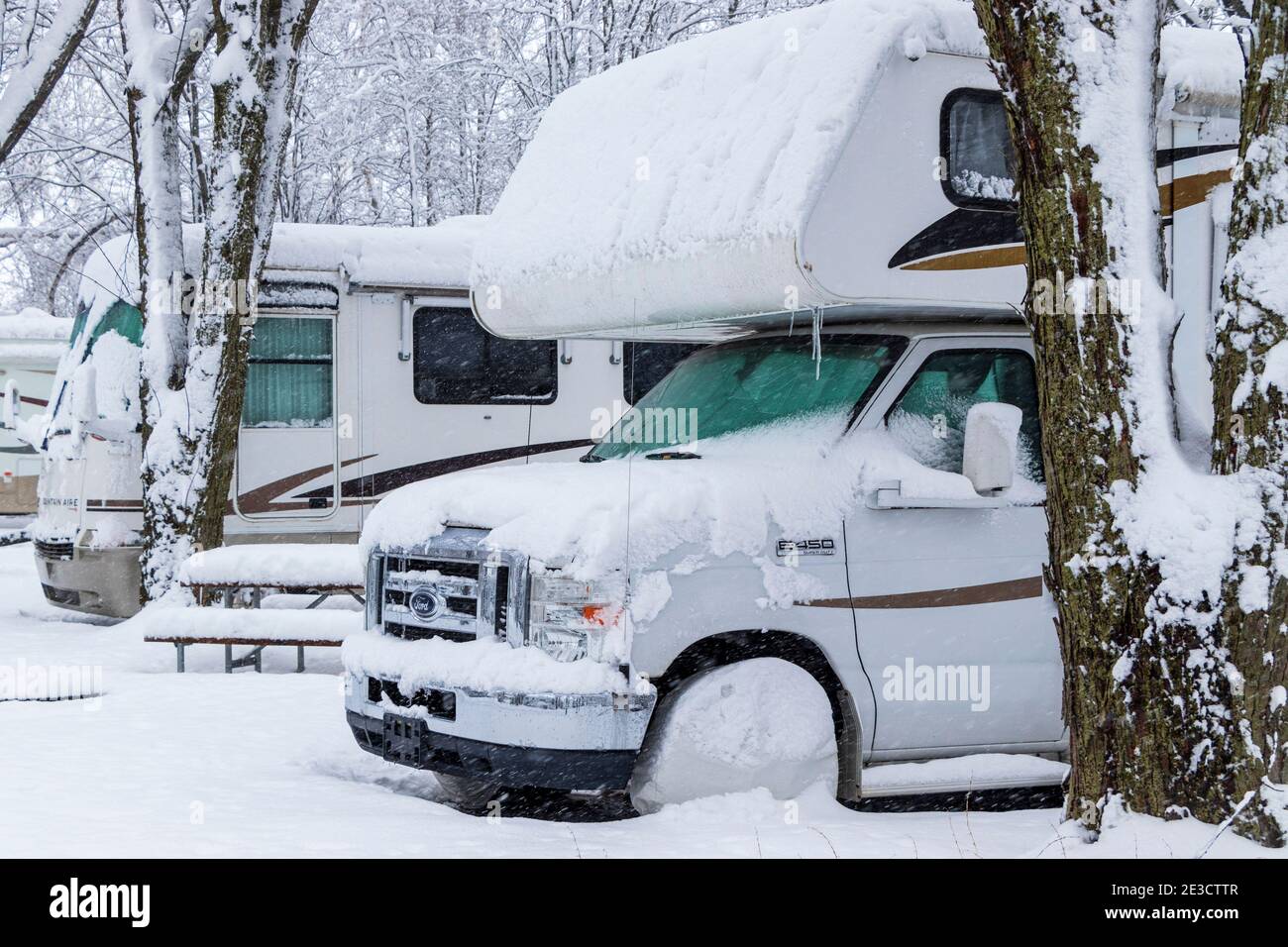 January 17, 2021 - Roxton Falls, Qc, Canada: RVs parked in a row on  campsites while snow storm, winterize, storage for winter season Stock Photo