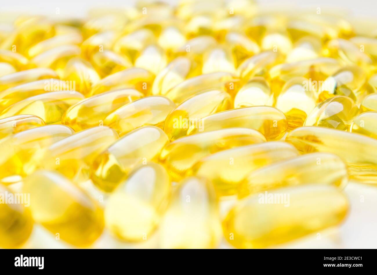 Fish oil fat capsules with omega 3 and vitamin D on white background