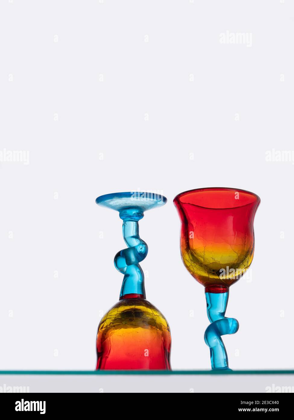Two colourful glasses seen from low angle below. Stock Photo