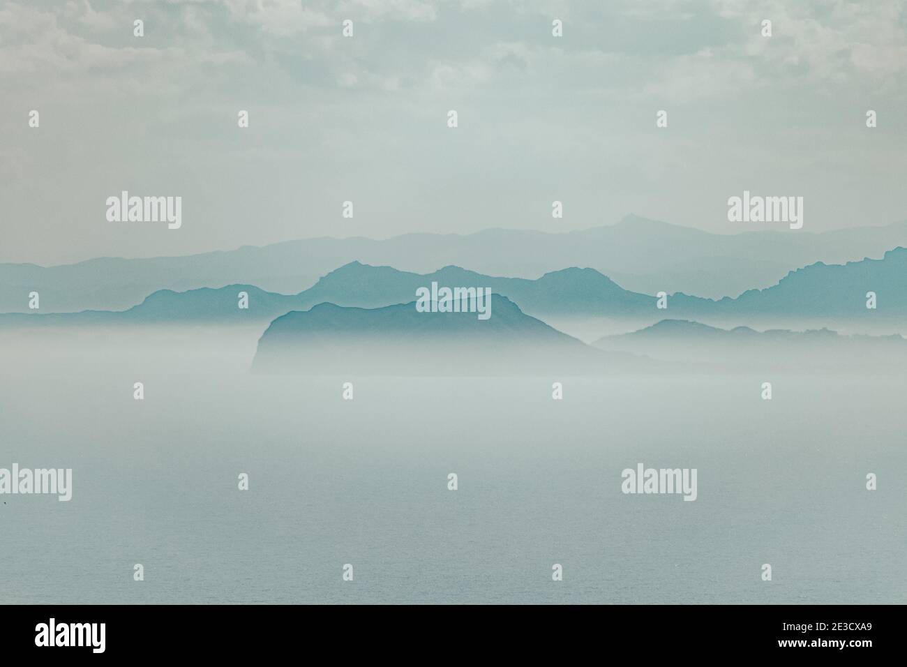 Peaks of mountains on a foggy day Stock Photo - Alamy
