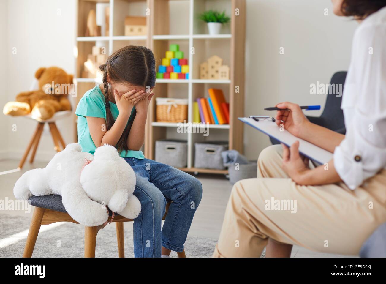 Bullying victim crying in psychotherapist's office unloading problems and seeking help Stock Photo