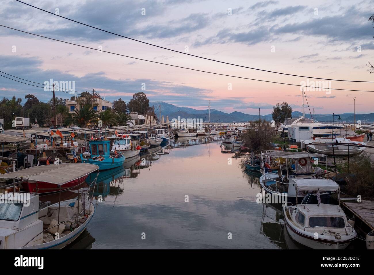 Tolo, Peloponesse, Greece - January 06, 2019: Fishing boats under the sunset Stock Photo
