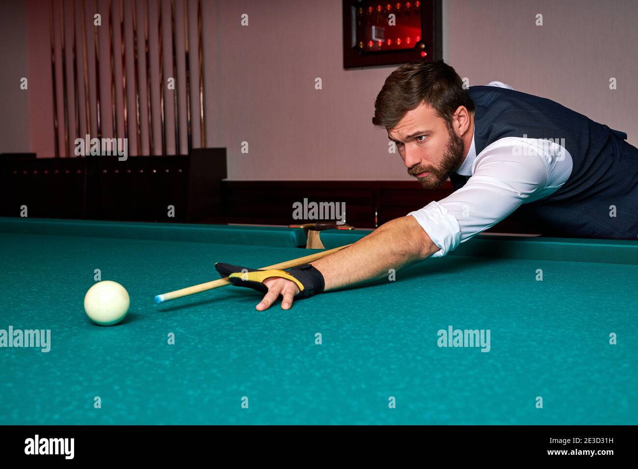 man holding arm on billiard table, playing snooker game or preparing
