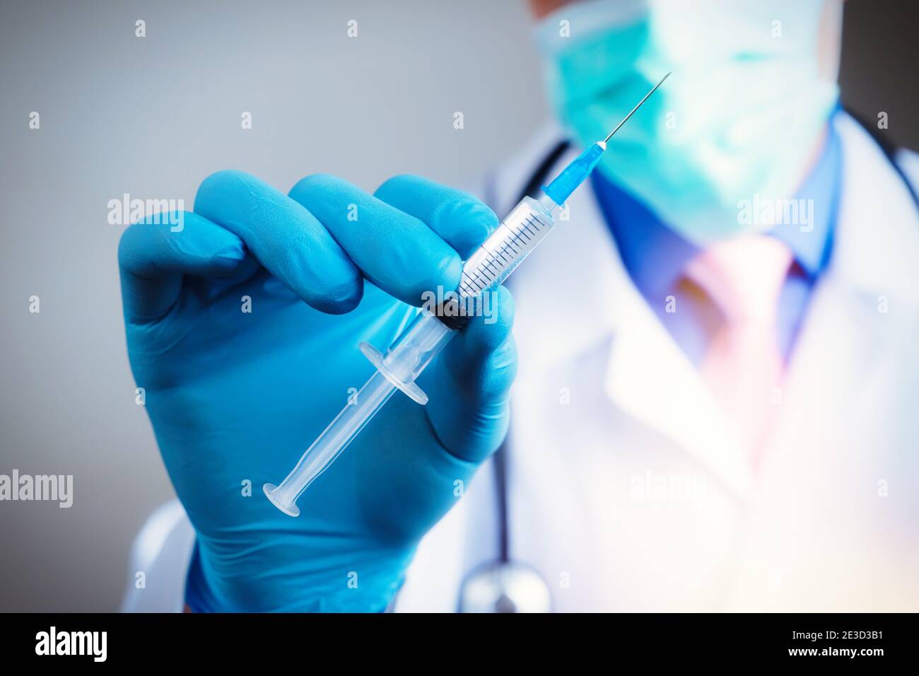 Close up hand of doctor in blue latex glove and medical gauze mask with
