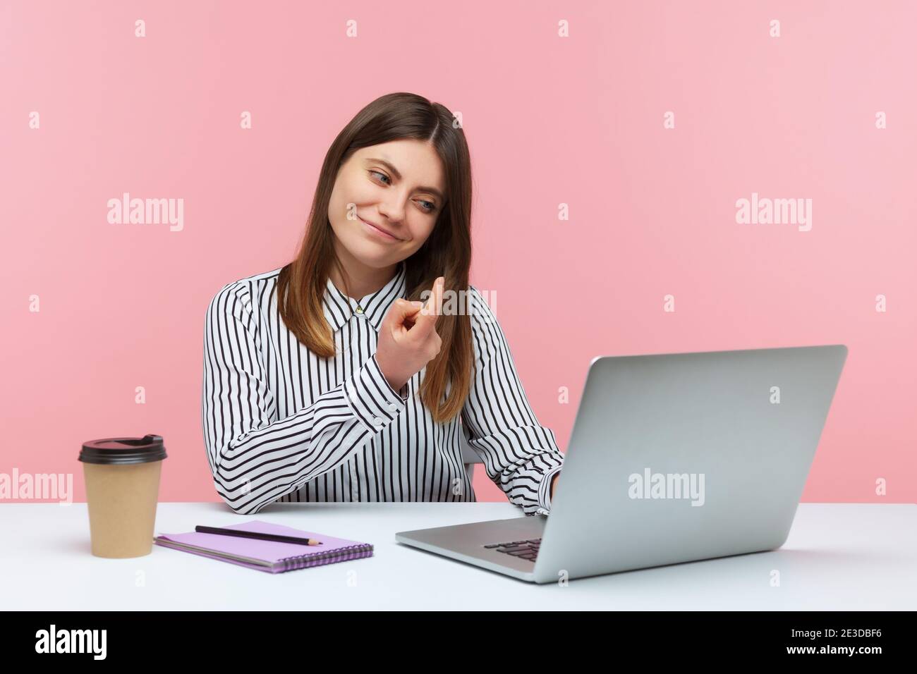Come here! Positive beautiful woman making beckoning gesture with finger talking on video call using laptop, having online romantic communication. Ind Stock Photo