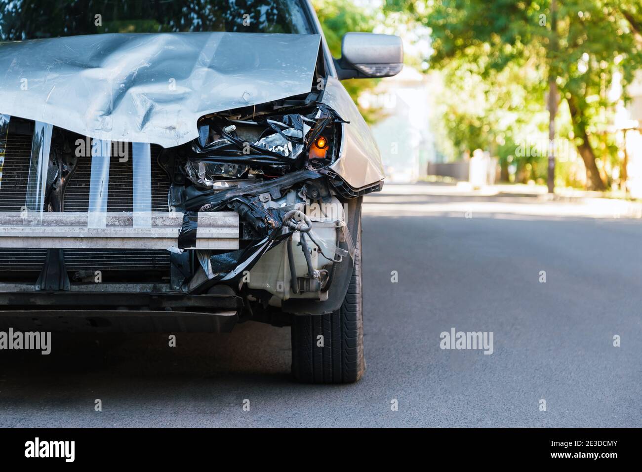 Destroyed car in car crash traffic accident on city road. Smashed