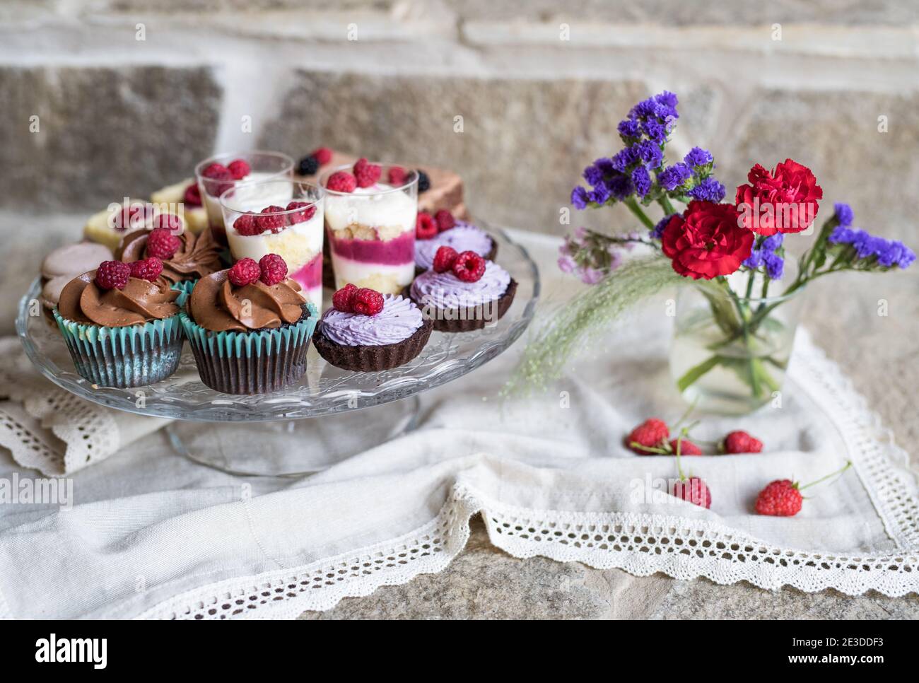 Selection of colorful and delicious cake desserts on tray on table. Stock Photo