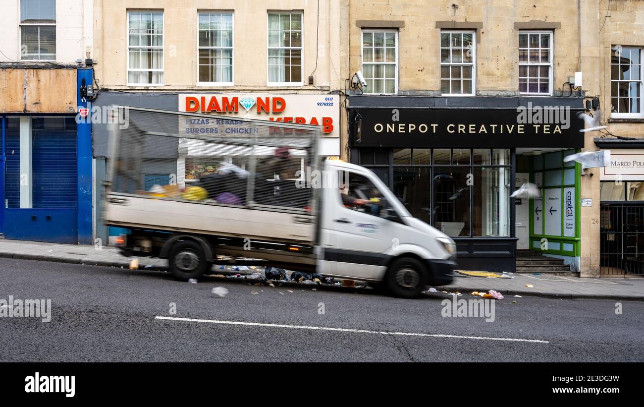 A refuse collection van pulls up to a take away resturant on Bristol's Park Street after sea gulls break opened rubbish bags early on a summer morning Stock Photo