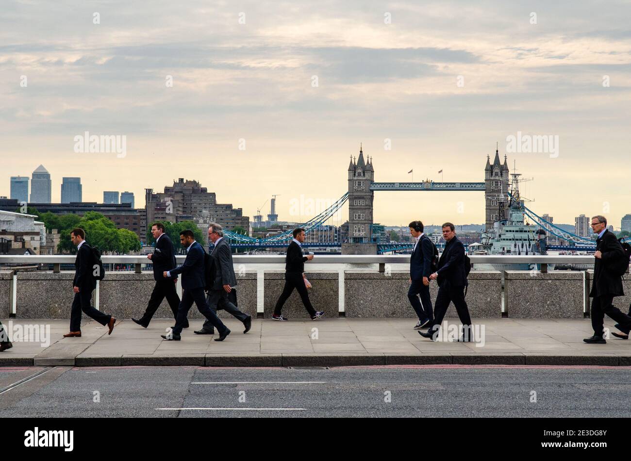 London, England - June 24, 2015: Commuters walking across London Bridge to offices in the 'square mile' City of London business district. Stock Photo